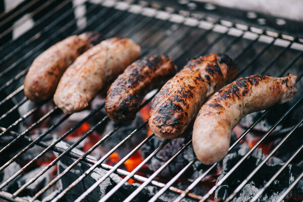 selective focus of grilled tasty sausages on bbq grill