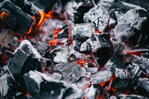 selective focus of hot burning coals in white ash