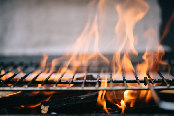 жжение дров с пламенем через решетки барбекю гриль
