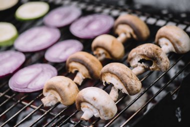 seçici odak çiğ soğan dilimleri ve Barbekü ızgara üzerinde ızgara mantar