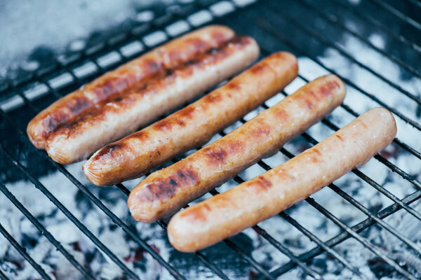 selective focus of tasty grilled sausages on bbq grill grade
