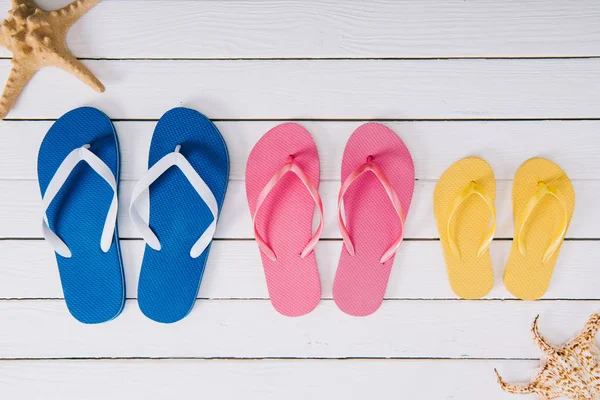 Top View Yellow Blue Pink Flip Flops White Wooden Background — Stock Photo, Image