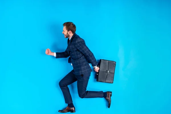 Young Man Suit Holding Briefcase Running Blue Background — Stock Photo, Image