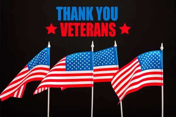american flags with thank you veterans lettering isolated on black
