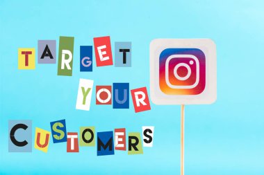 card with instagram logo and target your customers lettering isolated on blue clipart