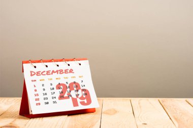 calendar with December 2019 lettering isolated on beige with copy space clipart