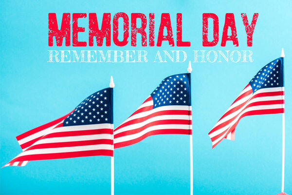 american flags with memorial day lettering on blue 