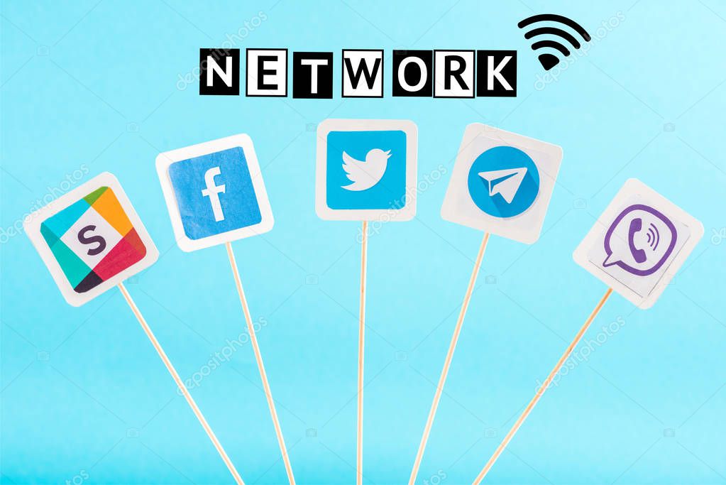 Social media icons and network lettering isolated on blue