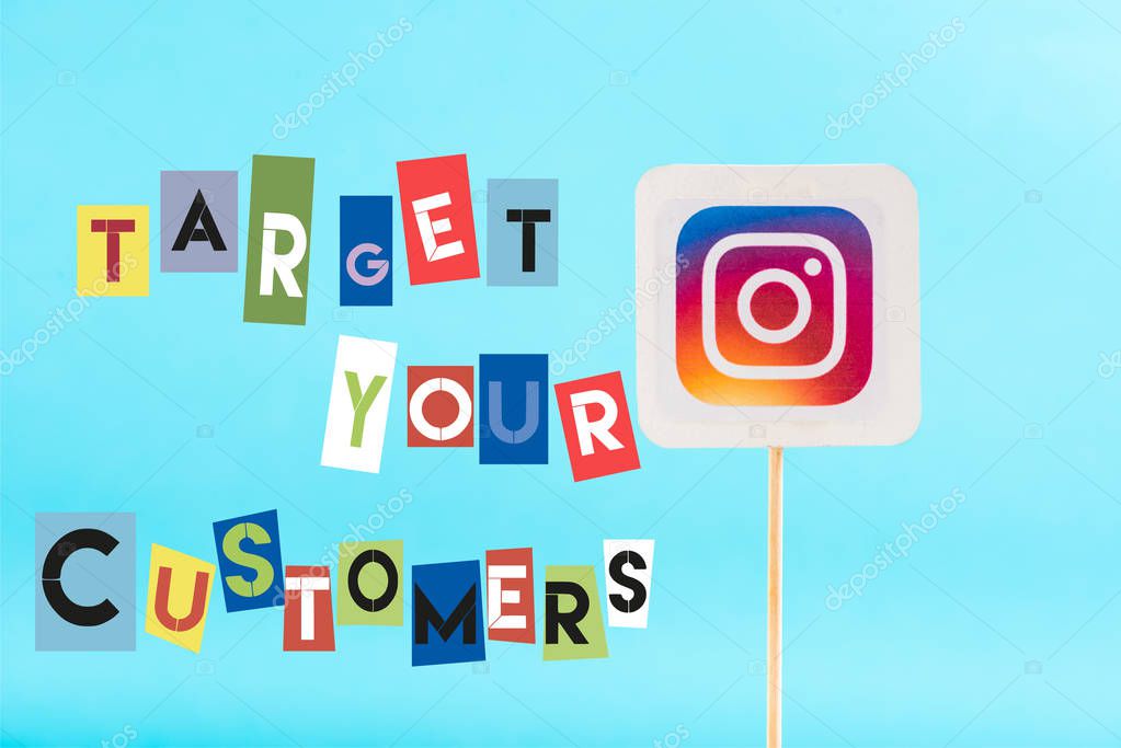 Card with instagram logo and target your customers lettering isolated on blue