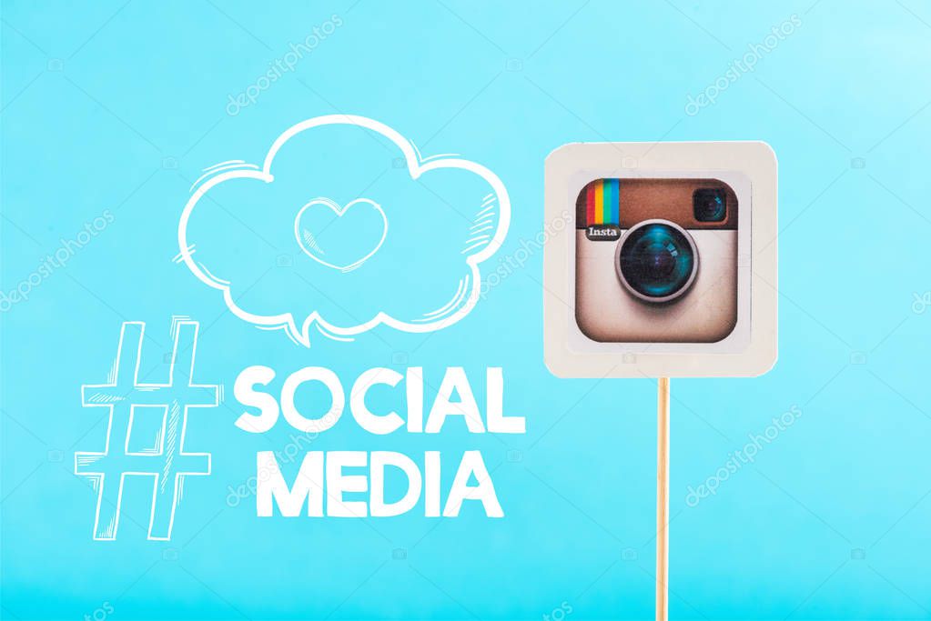 Card with instagram logo and social media lettering isolated on blue