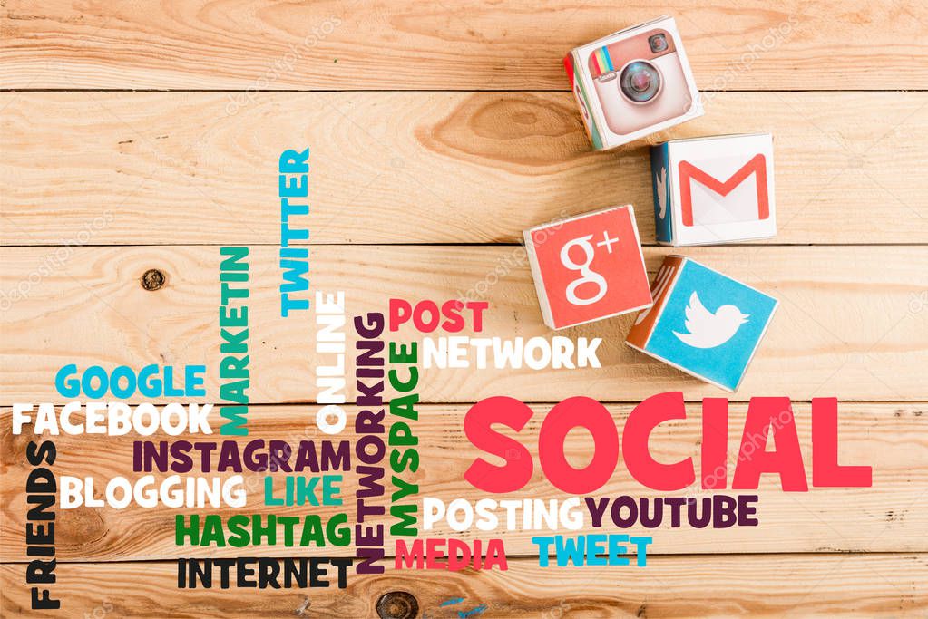 Top view of blocks with google plus, gmail, instagram and twitter logo on wooden table with social media illustration