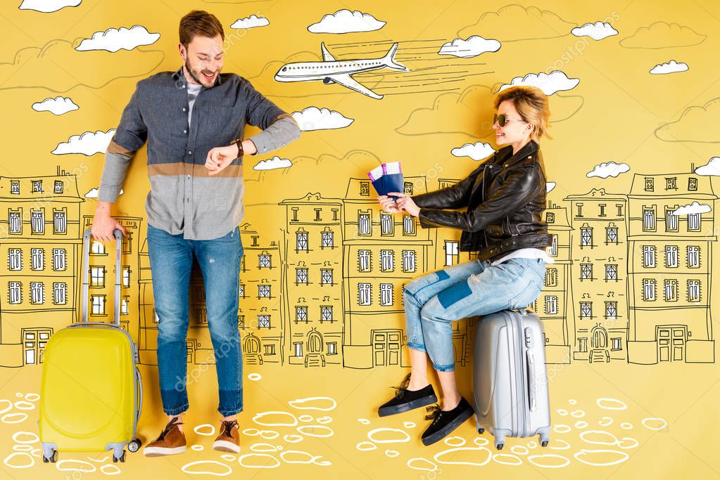 happy woman holding passports and tickets while man with suitcase checking time with city and airplane illustration on yellow background