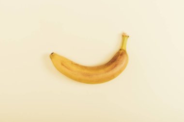 Top view of fresh bright and yellow banana on light beige background clipart