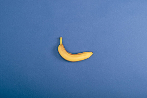 Top view of fresh and yellow banana on blue background with copy space