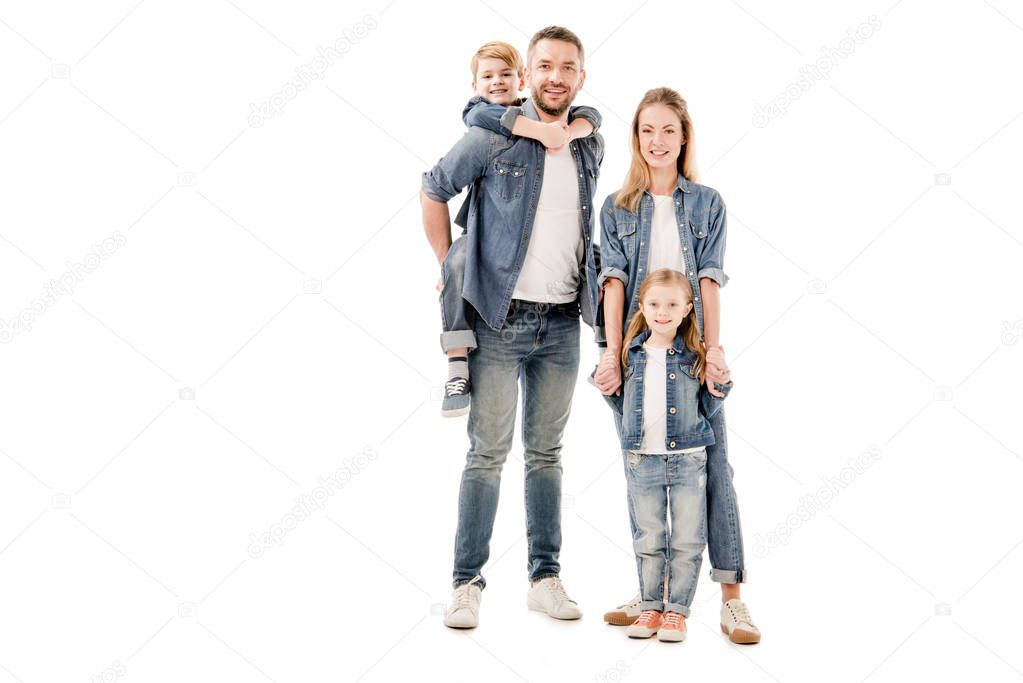 full length view of happy family in jeans smiling isolated on white