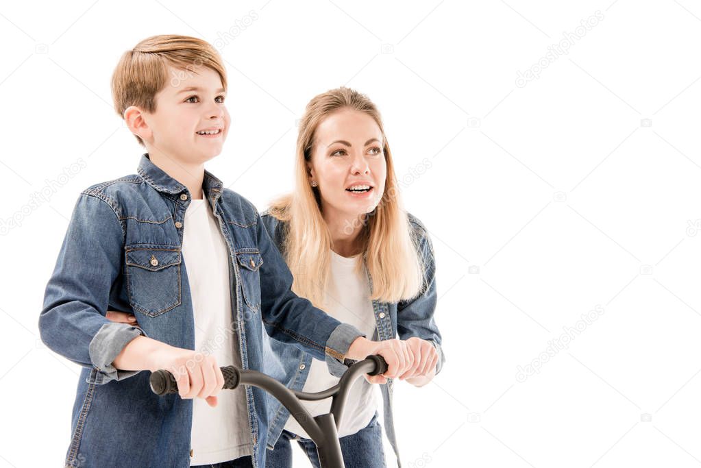 mother and son with scooter isolated on white