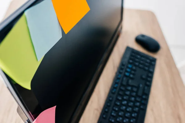 High angle view of colorful post its on blank computer monitor at table — Stock Photo