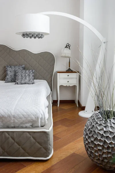 Interior of light bedroom in grey color with modern big lamp — Stock Photo