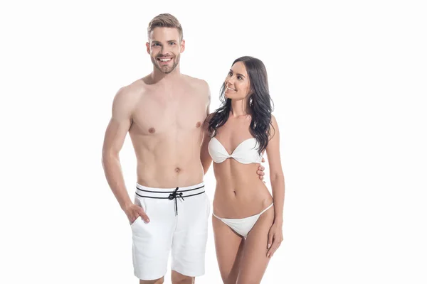 Young couple in swimwear embracing isolated on white — Stock Photo
