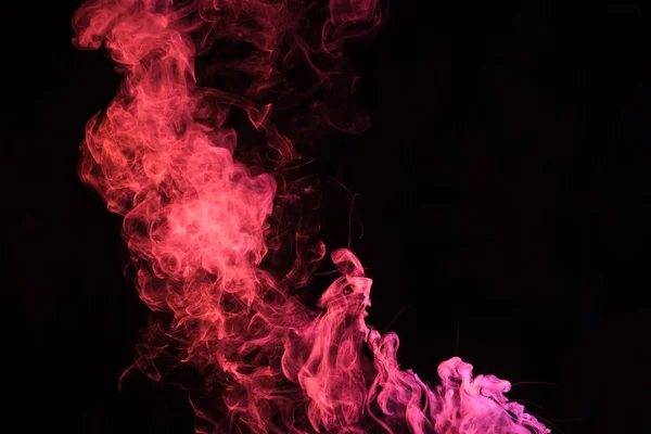 Pink spiritual smoky swirl on black background with copy space — Stock Photo
