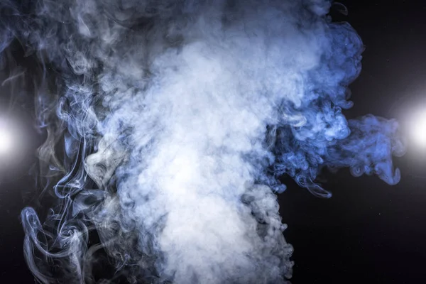 White smoke and glowing lights on black background — Stock Photo