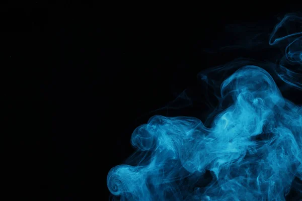 Blue spiritual smoke on black background with copy space — Stock Photo