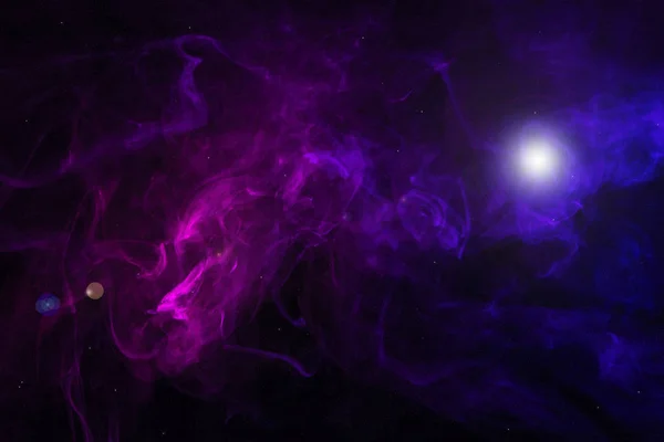 Purple and pink smoke with glowing light on black background — Stock Photo