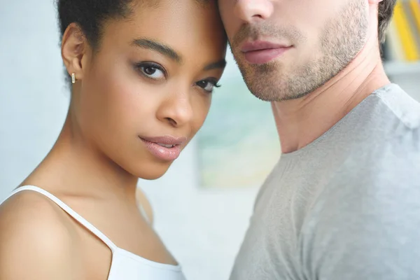 Partial view of multiethnic couple in love at home — Stock Photo