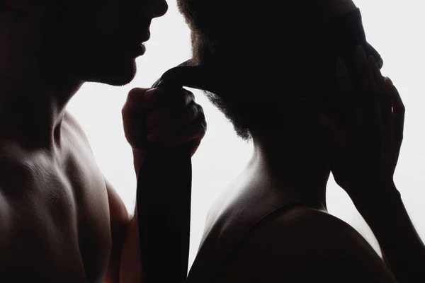 Partial view of silhouettes of sexy couple with cloth — Stock Photo
