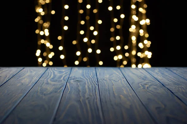 Empty wooden surface and beautiful golden lights bokeh background — Stock Photo