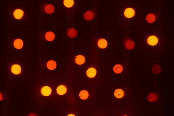 Beautiful shiny red, orange and yellow lights defocused bokeh background — Stock Photo