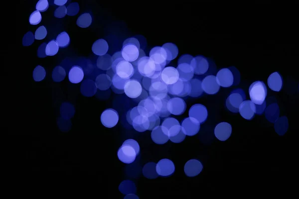 Bellissimo blu lucido bokeh sfocato su sfondo nero — Foto stock