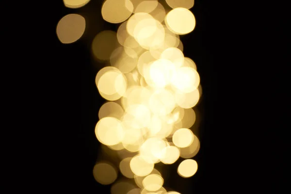 Schöne glänzende goldene Bokeh auf schwarzem Hintergrund — Stockfoto