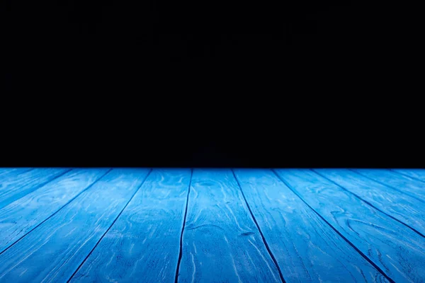 Empty light blue wooden planks surface on black background — Stock Photo