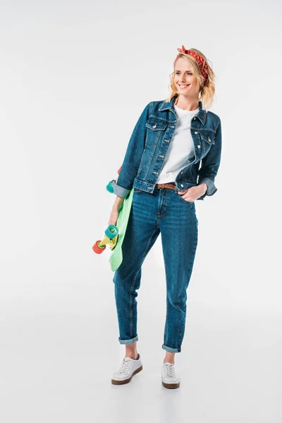 Sorrindo mulher atraente segurando skate isolado no branco — Fotografia de Stock