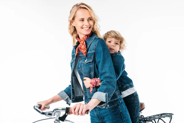 Smiling mother and son riding bicycle isolated on white — Stock Photo