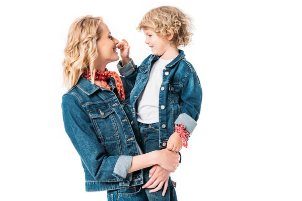 Happy mother holding son and he touching mothers nose isolated on white — Stock Photo