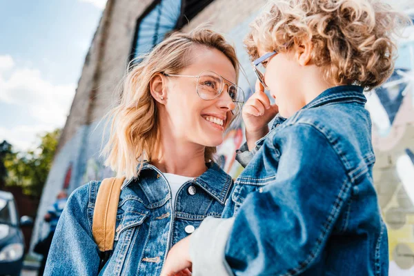 Happy mother and son looking at each other on street — Stock Photo