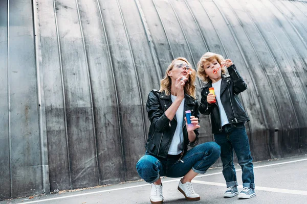 Mutter und Sohn pusten Seifenblasen auf Straße — Stockfoto