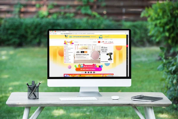 Selective focus of computer with aliexpress website at table outdoors — Stock Photo