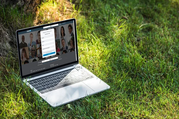 Close up view of laptop with linkedin website on grass outdoors — Stock Photo