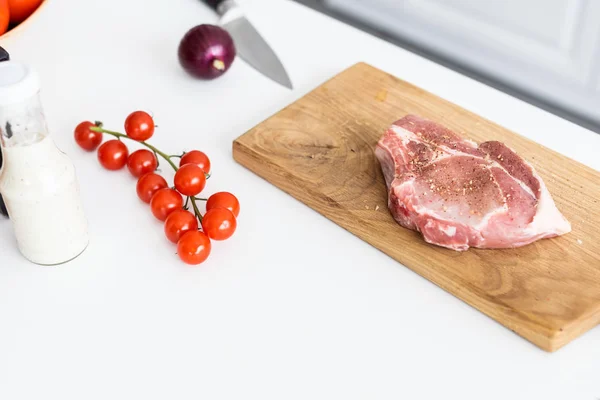 Close-up view of delicious raw steak on wooden cutting board — Stock Photo