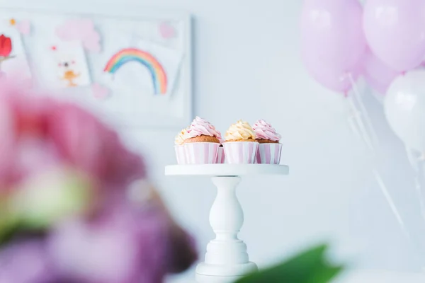 Focus selettivo di stand con cupcake e mazzo di palloncini d'aria — Foto stock