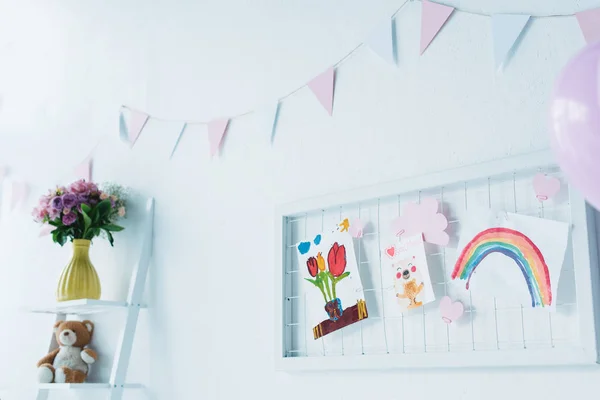 Decorated for birthday room with balloons and child paintings — Stock Photo