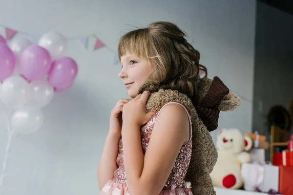 Petit enfant souriant debout avec ours en peluche sur les épaules — Photo de stock