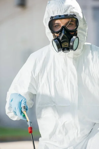 Portrait of pest control worker in respirator looking at camera — Stock Photo