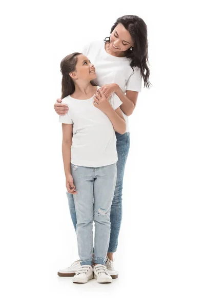 Happy mother and daughter looking at each other isolated on white — Stock Photo