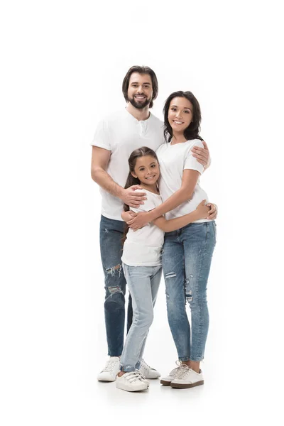 Família feliz em camisas brancas e jeans olhando para a câmera isolada no branco — Fotografia de Stock