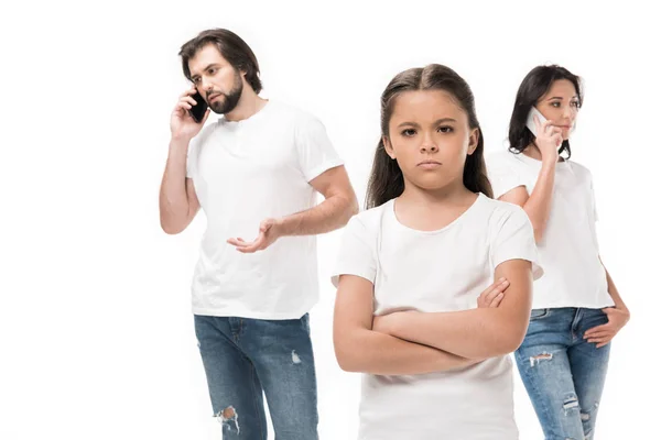Selective focus of upset kid and parents talking on smartphones isolated on white — Stock Photo