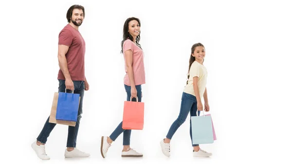 Side view of family with shopping bags isolated on white — Stock Photo